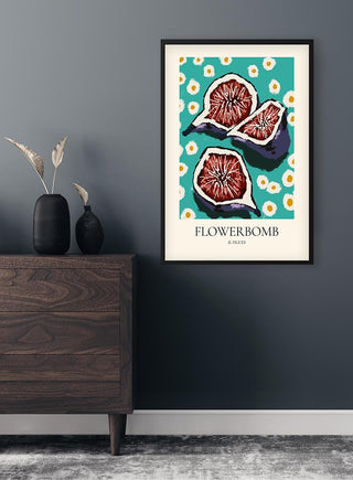 Framed Flowerbomb Il Figues Plakat with illustrated figs and floral patterns hanging on a modern dark wall.