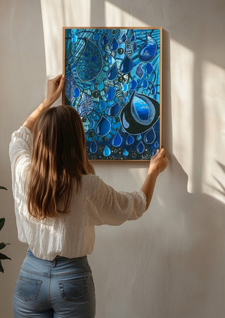 Blue Raindrops by JHN.ByHjort being hung on a sunlit wall