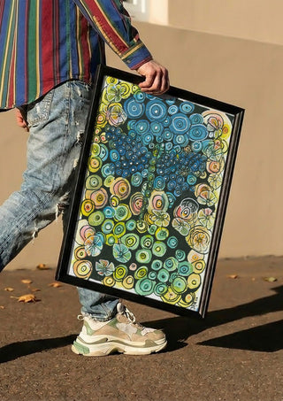 Tree of Circles by JHN.ByHjort carried in a black frame along a sunny street