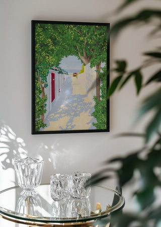 Story of light by Jaron Su in a black frame above a glass table with crystal glassware