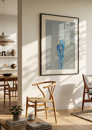Blue ChrysAlice by Alice Ruja in a black frame in a bright dining room with wooden chairs