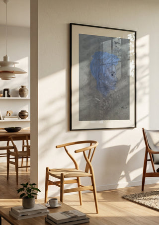Portrait in Blue by Allheartsportraits in a black frame in a bright dining room with wooden chairs