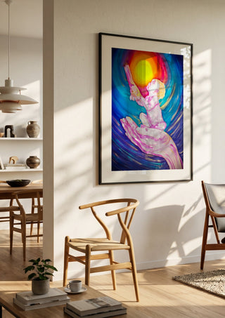 Cosmic Visions 2 by Walter Zettl in a black frame in a bright dining room with wooden chairs