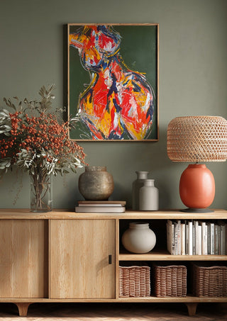 Red Figure by René J above a wooden sideboard on a sage green wall