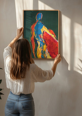 Figure in Green by René J being hung on a sunlit wall