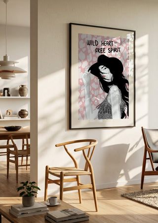 Wild heart, free spirit by Lisen Vennesland in a black frame in a bright dining room with wooden chairs
