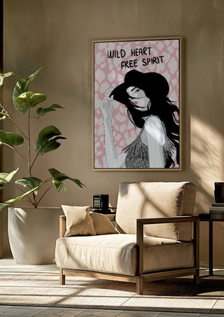 Wild heart, free spirit by Lisen Vennesland framed above a beige armchair beside a potted plant