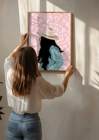Cowgirls are forever by Lisen Vennesland being hung on a sunlit wall