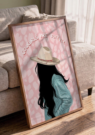 Cowgirls are forever by Lisen Vennesland in a walnut frame leaning against a grey sofa