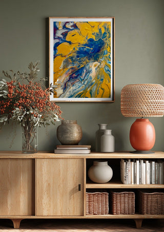 Gold and Indigo by Da Winters above a wooden sideboard on a sage green wall