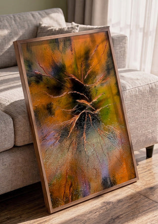 Copper Branches by Da Winters in a walnut frame leaning against a grey sofa