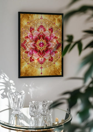 Flower of life by RA in a black frame above a glass table with crystal glassware