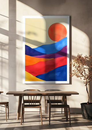 Red sun over colourful hills by Ohkimiko hanging above a wooden dining table in warm sunlight