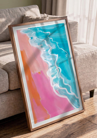 Pink hour on the beach by Ohkimiko in a walnut frame leaning against a grey sofa