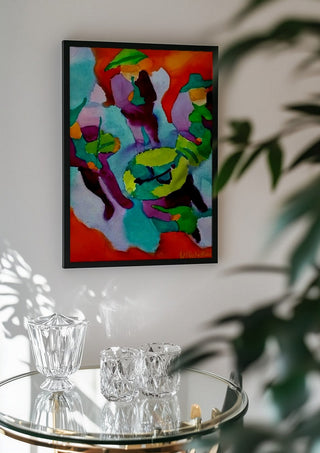 Mariachis by Nittaart in a black frame above a glass table with crystal glassware