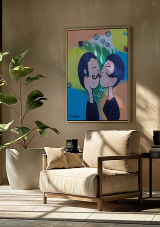 Der Kuss im Glücksregen by Trude framed above a beige armchair beside a potted plant