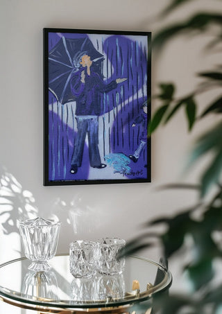 Tanz durch den Regen by Trude in a black frame above a glass table with crystal glassware