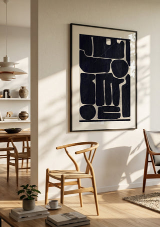 Modern Abstract Minimal Shapes 162 by ThingDesign in a black frame in a bright dining room with wooden chairs
