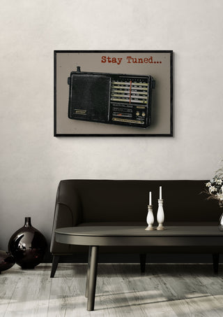 Stay Tuned by Carl Smith ART in a black frame above a dark sofa with candlesticks on a round table