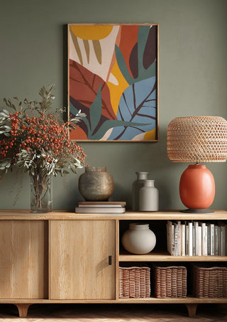Abstract Art Jungle by ThingDesign above a wooden sideboard on a sage green wall