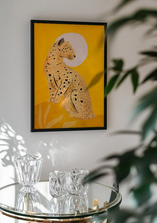 Leopard by ThingDesign in a black frame above a glass table with crystal glassware