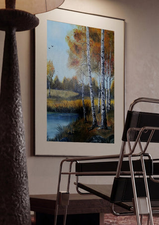 Autumn Birches by the Pond by Lüba framed in a dim room beside a tubular steel chair