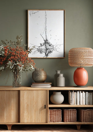 Ship and Gulls by Justyna Kopania above a wooden sideboard on a sage green wall