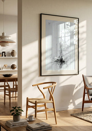 Two Masts by Justyna Kopania in a black frame in a bright dining room with wooden chairs