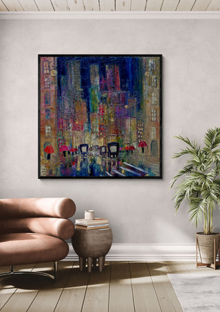Rain on the Boulevard by Justyna Kopania in a black frame above a leather armchair beside a palm