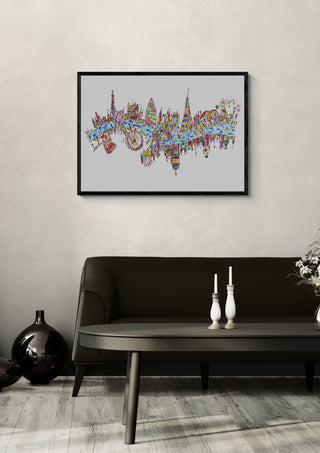 London by ullimcart in a black frame above a dark sofa with candlesticks on a round table