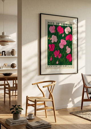 POIS DE SENTEUR by Annika Persson in a black frame in a bright dining room with wooden chairs