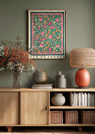 Vie de Jardin by Annika Persson above a wooden sideboard on a sage green wall
