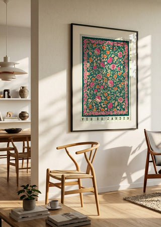 Vie de Jardin by Annika Persson in a black frame in a bright dining room with wooden chairs