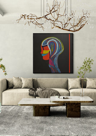 RED LINE by Ali Kasap in a black frame above a cream sofa under a branch chandelier