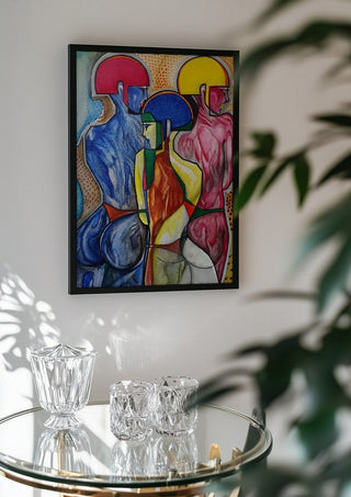 The 3 Graces by inksideme in a black frame above a glass table with crystal glassware
