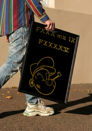 FXXX MX IX FXXXXV by Ali Kasap carried in a black frame along a sunny street