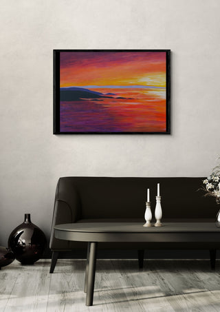 Evening Light by Finbar Stevens Art in a black frame above a dark sofa with candlesticks on a round table