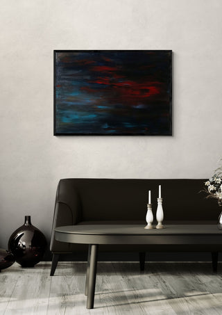 A man's frustration by PeKo in a black frame above a dark sofa with candlesticks on a round table