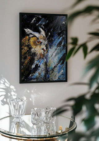 Silent wisdom by Lüba in a black frame above a glass table with crystal glassware