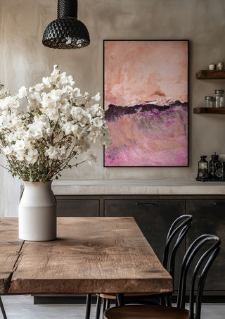 expressive landscape by Iris Lehnhardt in a black frame above a rustic table with white flowers