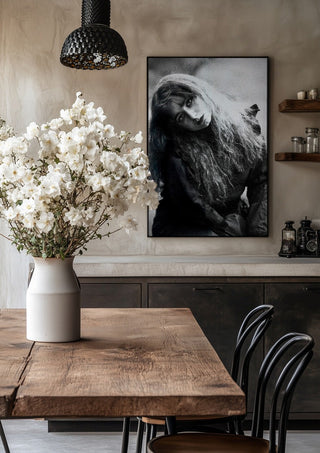 Wind in Her Hair by Bettinafloorphoto in a black frame above a rustic table with white flowers