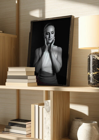 Quiet Light by Bettinafloorphoto in a dark frame on a wooden shelf beside books and a lamp