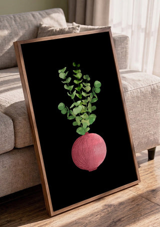 Eucalyptus in pink vase by Creationsbyeditabrus in a walnut frame leaning against a grey sofa