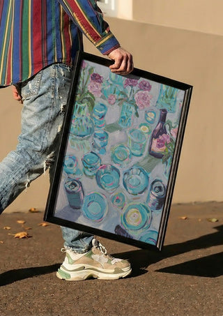 Garden Summer Party by DNF carried in a black frame along a sunny street