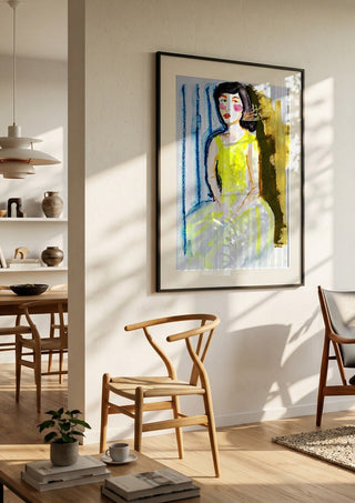 Yellow Dress by DNF in a black frame in a bright dining room with wooden chairs