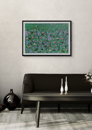Paddy's Yard by Rebecca Wright in a black frame on a pale wall above a dark sofa with candlesticks