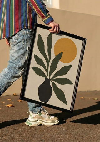 Minimalist Botanical Still Life with Sun by TimlessArtworks carried in a black frame along a sunny street