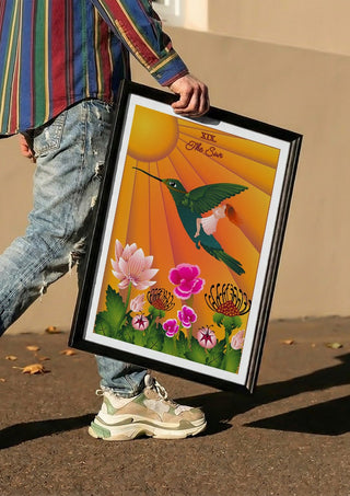The Sun by Sciurus tarotus carried in a black frame along a sunny street