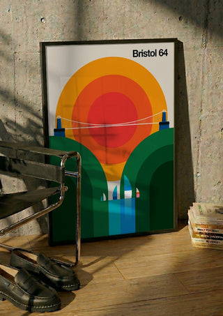 Bristol 64 by Bo Lundberg in a black frame leaning against a concrete wall by a steel chair