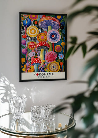 Mushroom and Flower Garden by Yokohama in a black frame above a glass table with crystal glassware